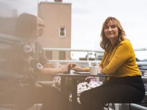 Woman having a coffee break on a balcony in a law firm