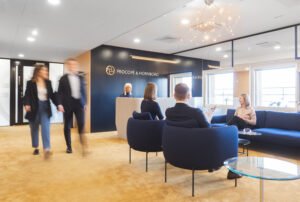 People walking and smiling in a law firm's lobby