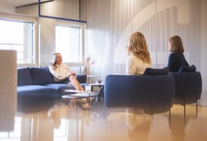 People sitting in a law firm lobby, smiling and engaging