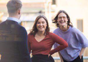 Two smiling young women at a law firm